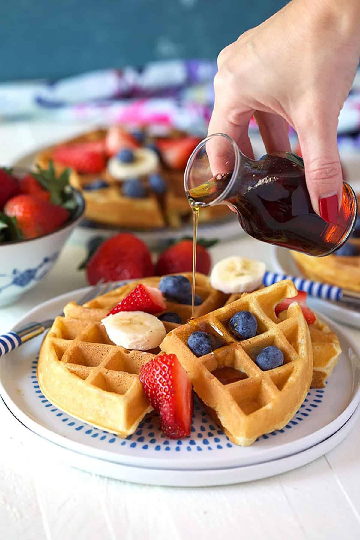 Il Migliore Waffle Belga Casalingo 2 Waffle belga con frutta fresca e sciroppo d'acero versato sopra.