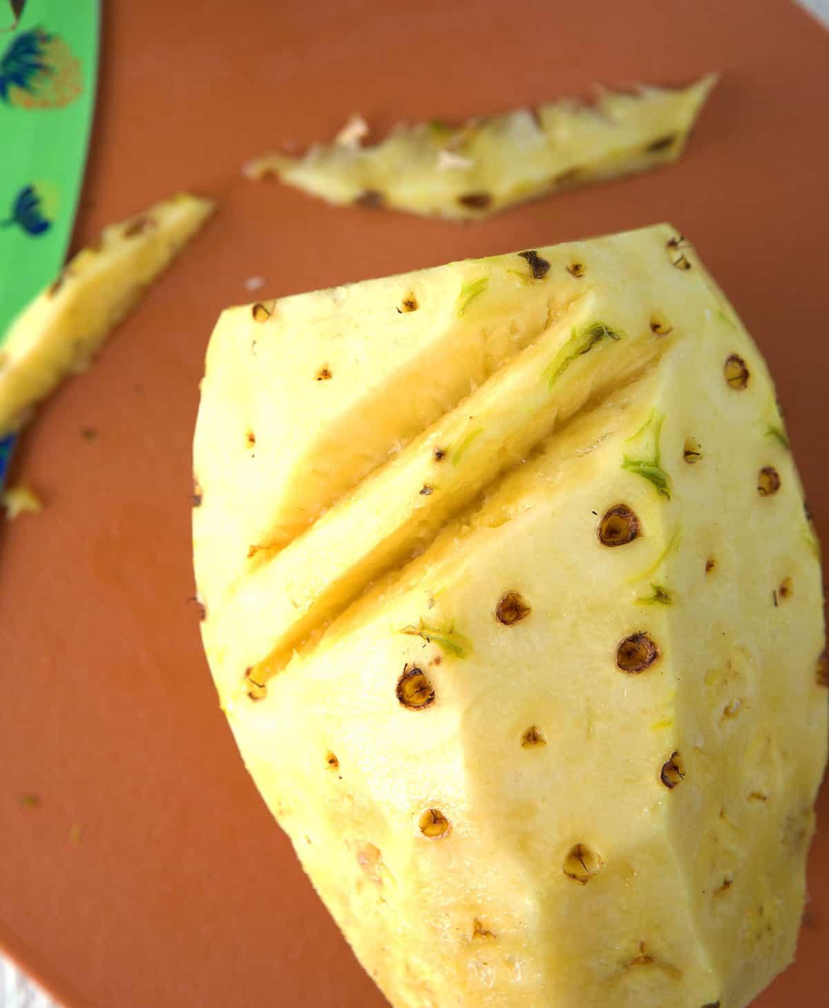 Come Tagliare un Ananas 4 Gli occhi dell'ananas vengono tagliati.