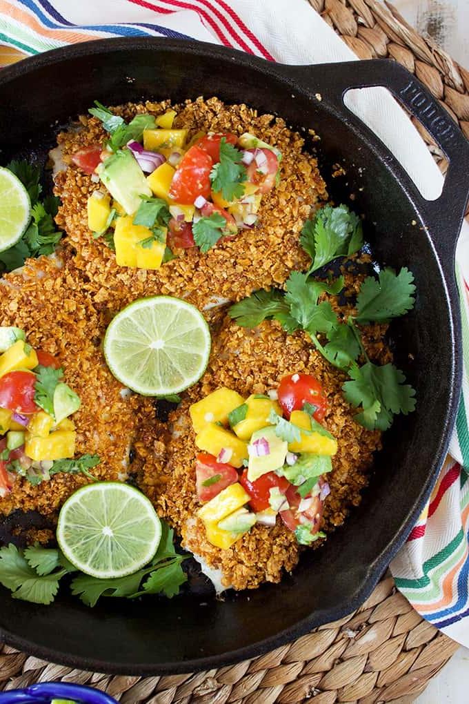 Merluzzo al Forno al Limone e Verdure 8 Pronta in soli 20 minuti, questa facile ricetta di Tilapia con crosta di tortilla è condita con una salsa semplice e rinfrescante di avocado e mango! | @suburbansoapbox TheSuburbanSoapbox.com