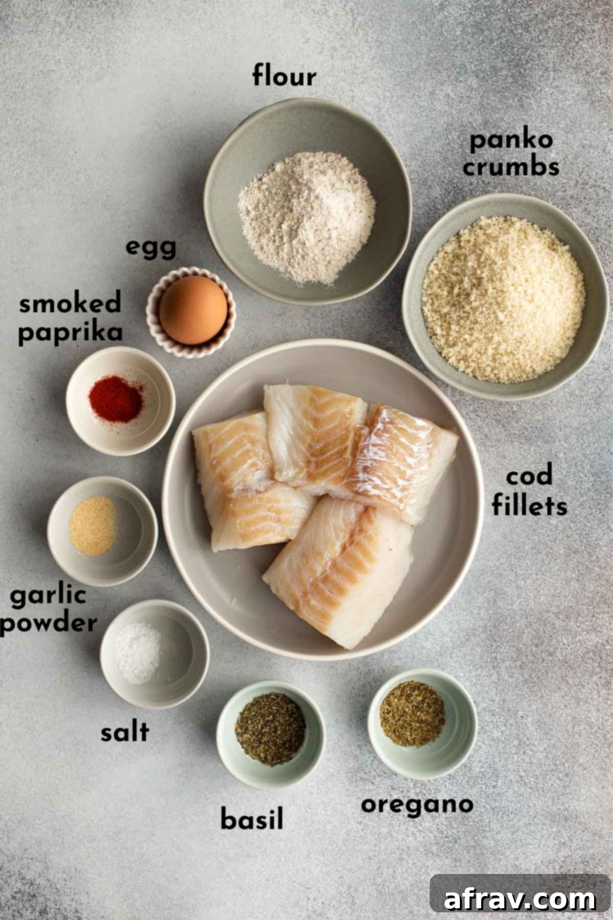 Overhead view of ingredients to make air fried cod arranged individually and labelled.
