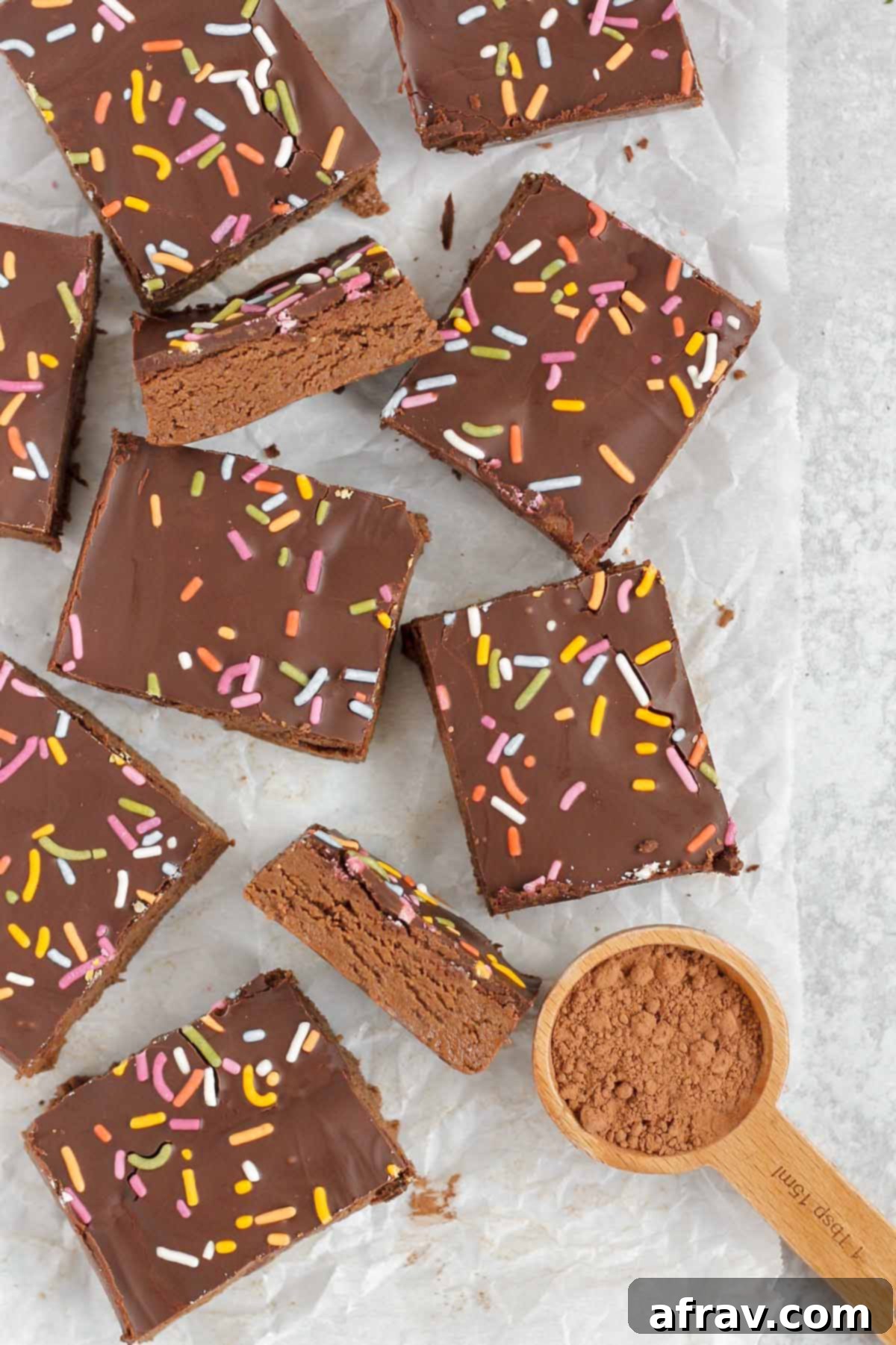 Homemade No-Bake Chocolate Protein Bars 2 Cut up chocolate protein bars on crinkled white parchment paper.