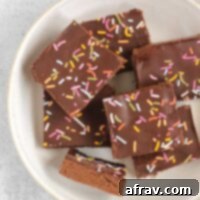 Homemade No-Bake Chocolate Protein Bars 7 Chocolate protein with sprinkles laid out on a white plate.