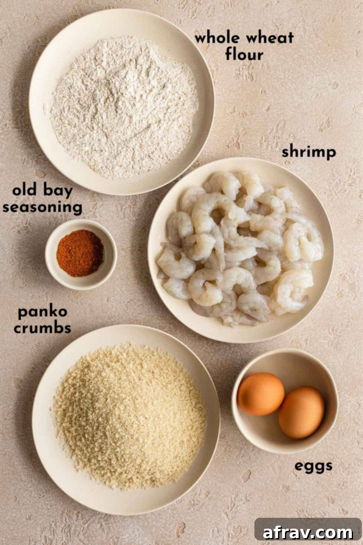 Ingredients to make breaded shrimp arranged individually and labelled.