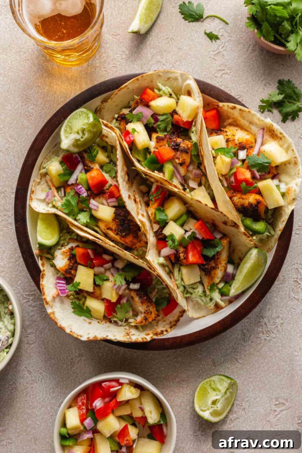 Crispy Air Fryer Fish Tacos 2 Fish tacos topped with pineapple salsa and arranged in a round serving dish.