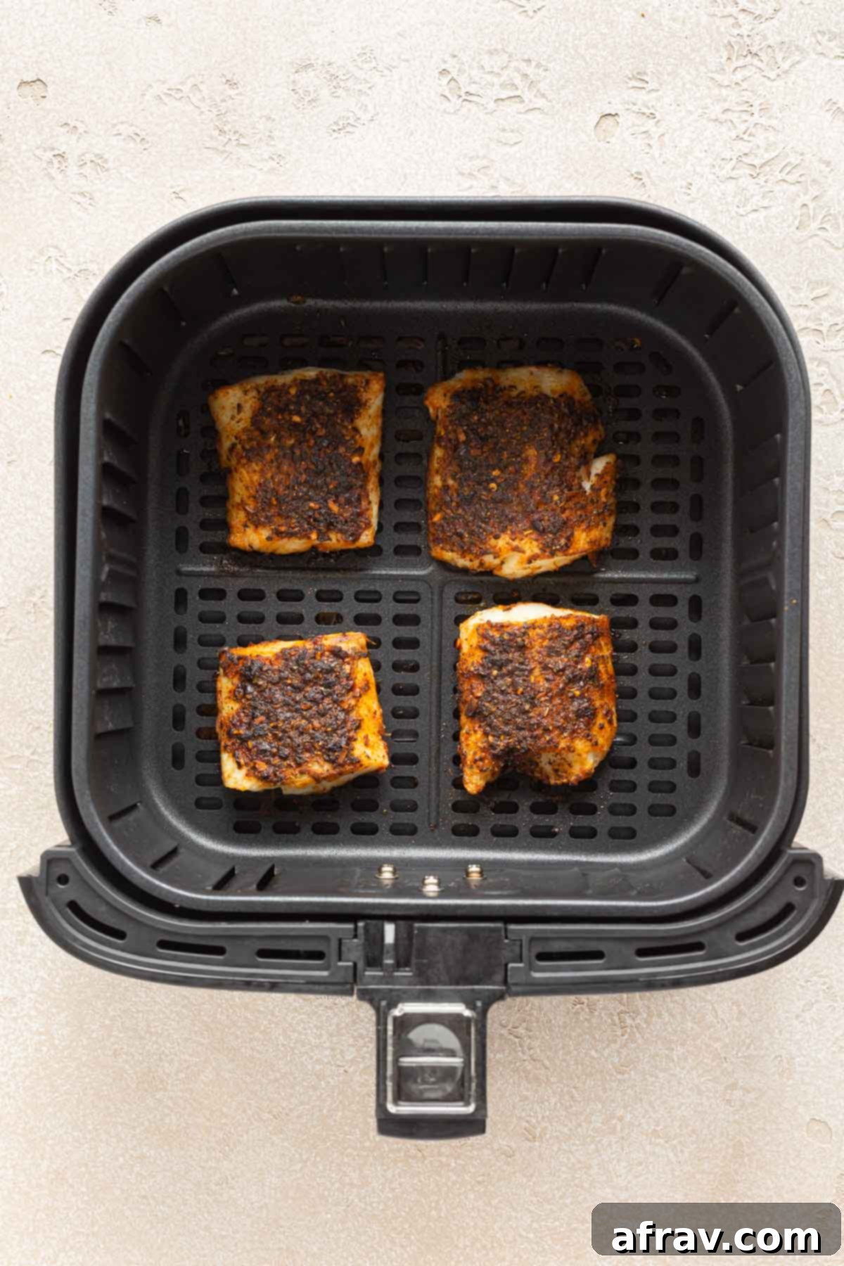 Crispy Air Fryer Fish Tacos 5 Air fried cod pieces in an air fryer basket.