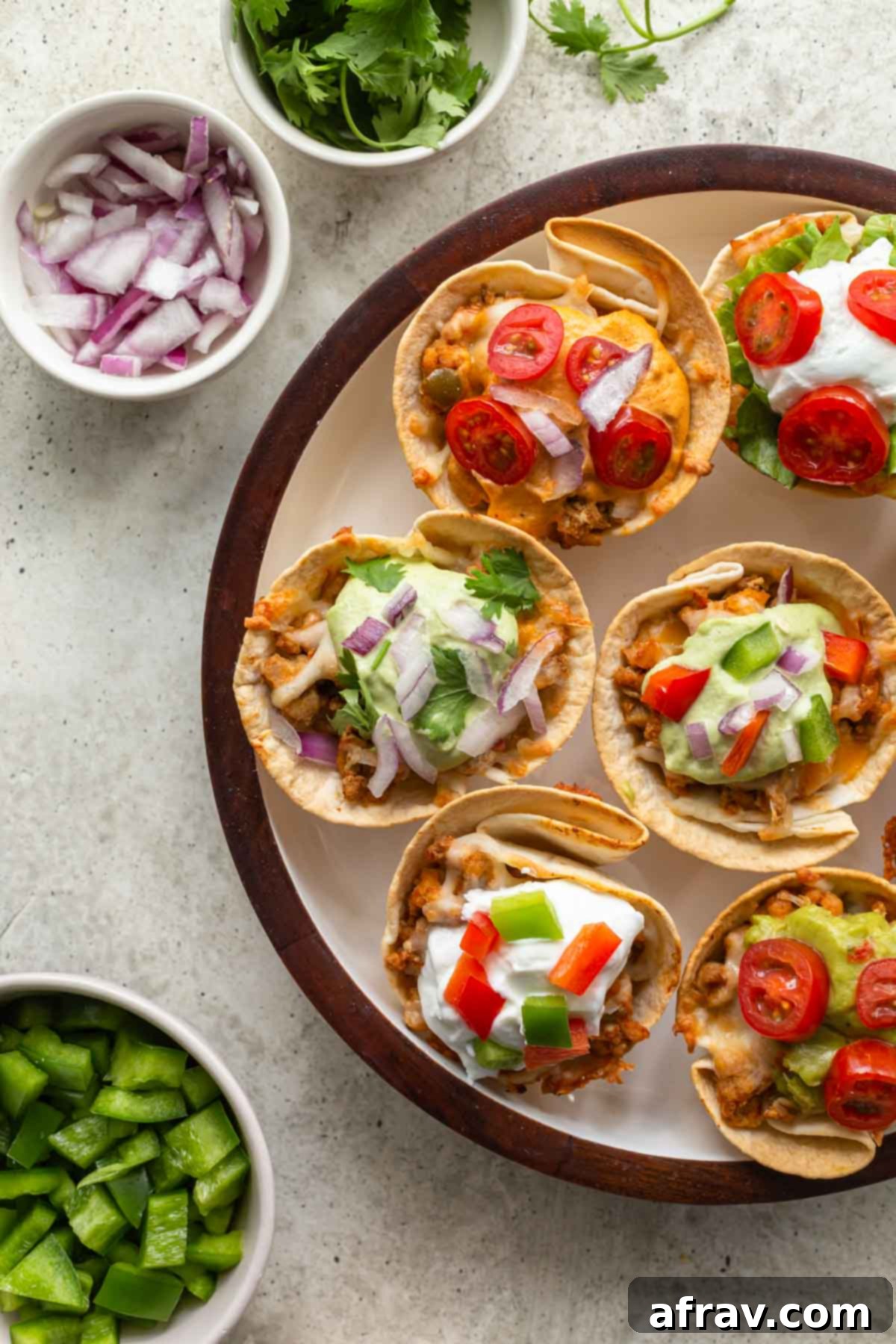 Up close and overhead view of ground turkey taco cups beautifully arranged on a white plate, ready to be served.