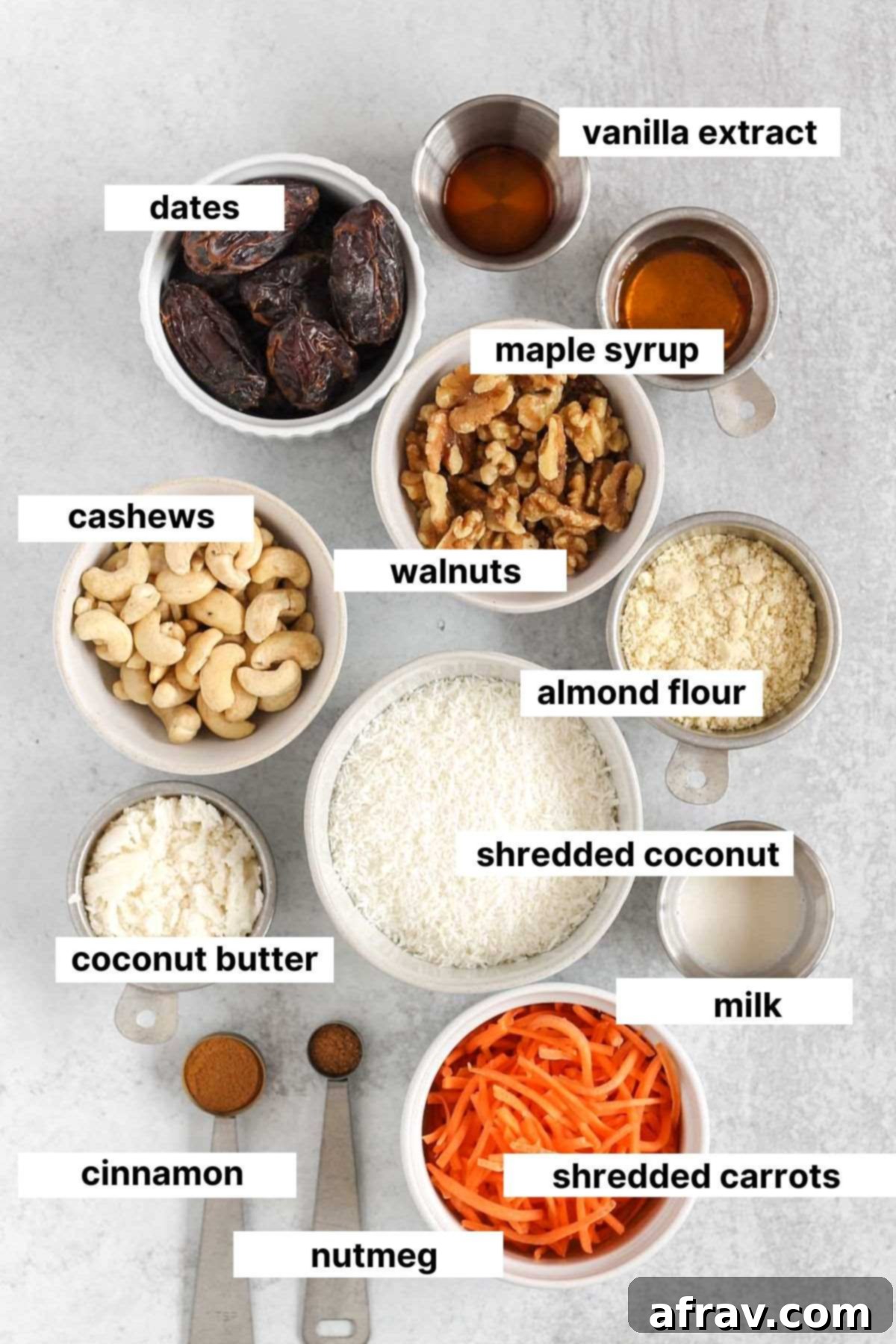 Labeled ingredients needed for no-bake carrot cake balls, including carrots, dates, nuts, coconut, almond flour, and spices.
