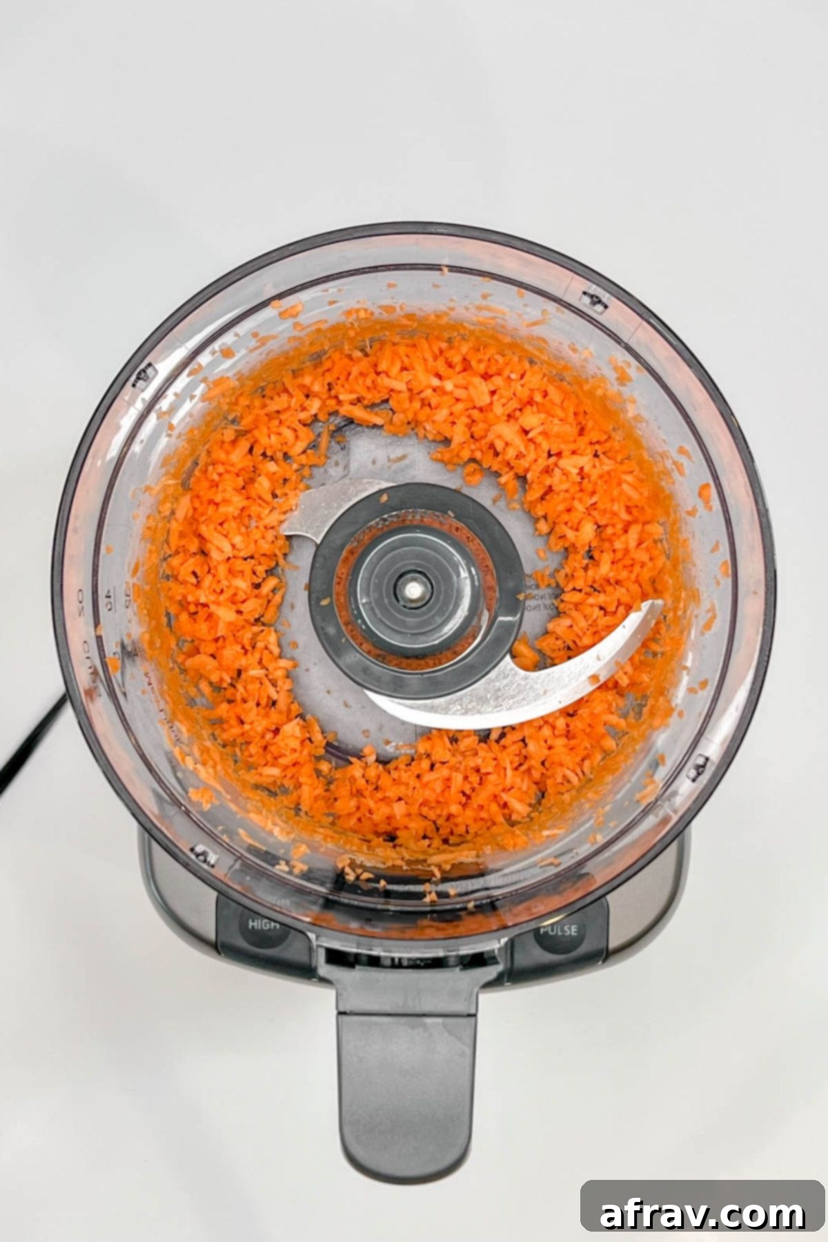 Shredded carrots in a food processor.