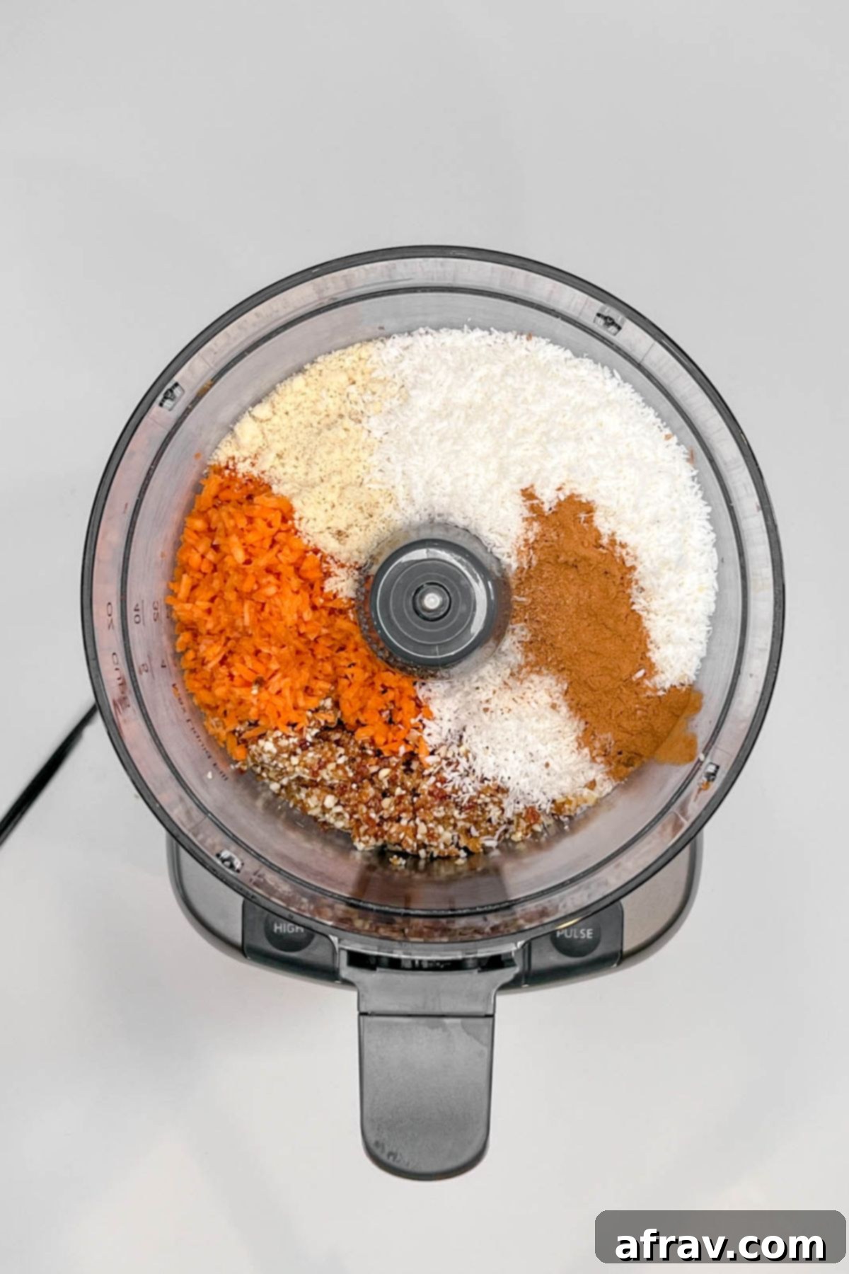 Carrot cake energy ball ingredients in a food processor.