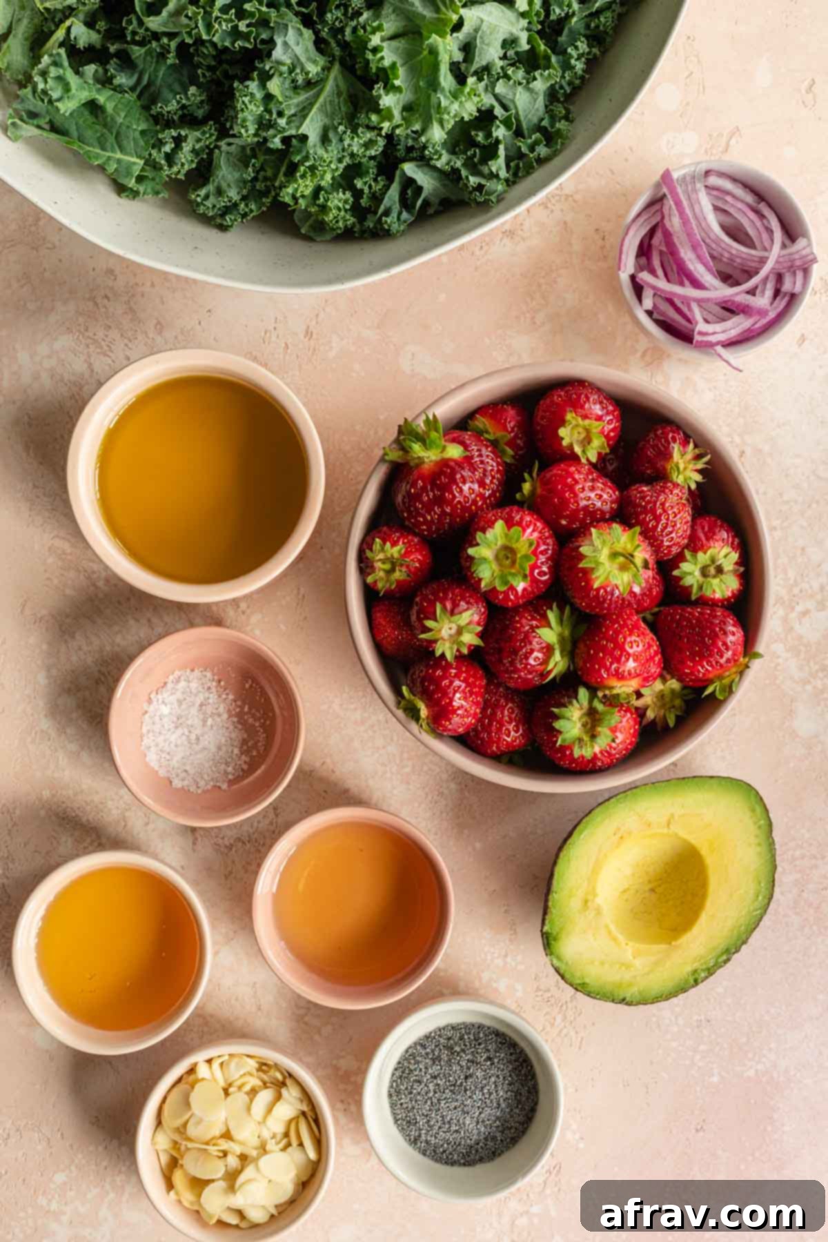 Vibrant Strawberry Kale Salad 3 Overhead of ingredients to make strawberry kale salad arranged individually, vibrant and fresh.