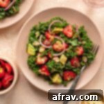 Vibrant Strawberry Kale Salad 6 Strawberry kale salad on a pink plate.