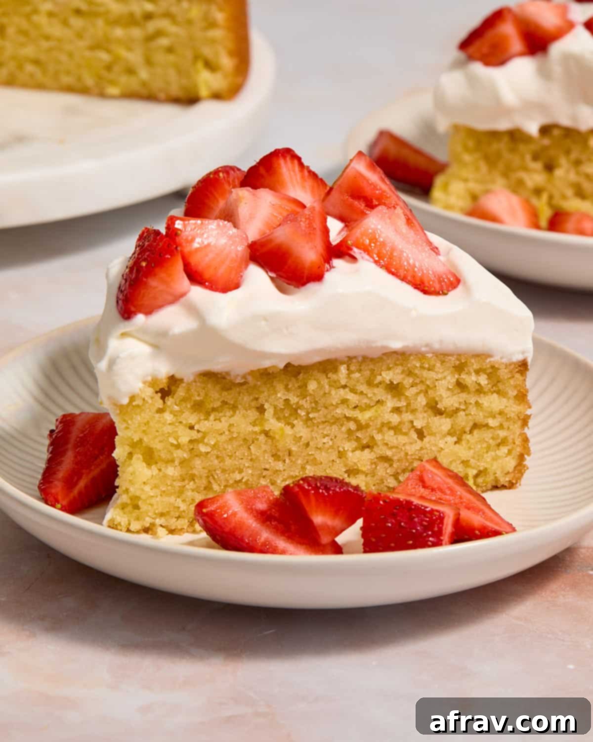 Slice of cake on a plate with strawberries.