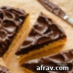 A beautifully frosted slice of cake topped with a generous swirl of chocolate avocado frosting, ready to be enjoyed.