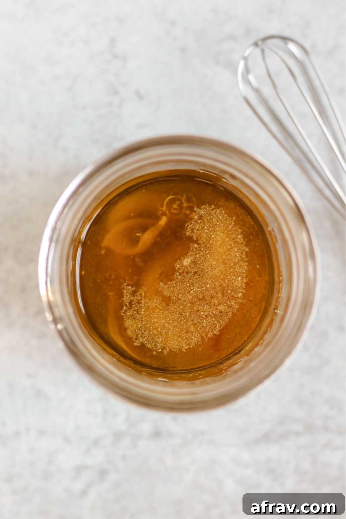 Ingredients for maple Dijon salad dressing in a mason jar unmixed.