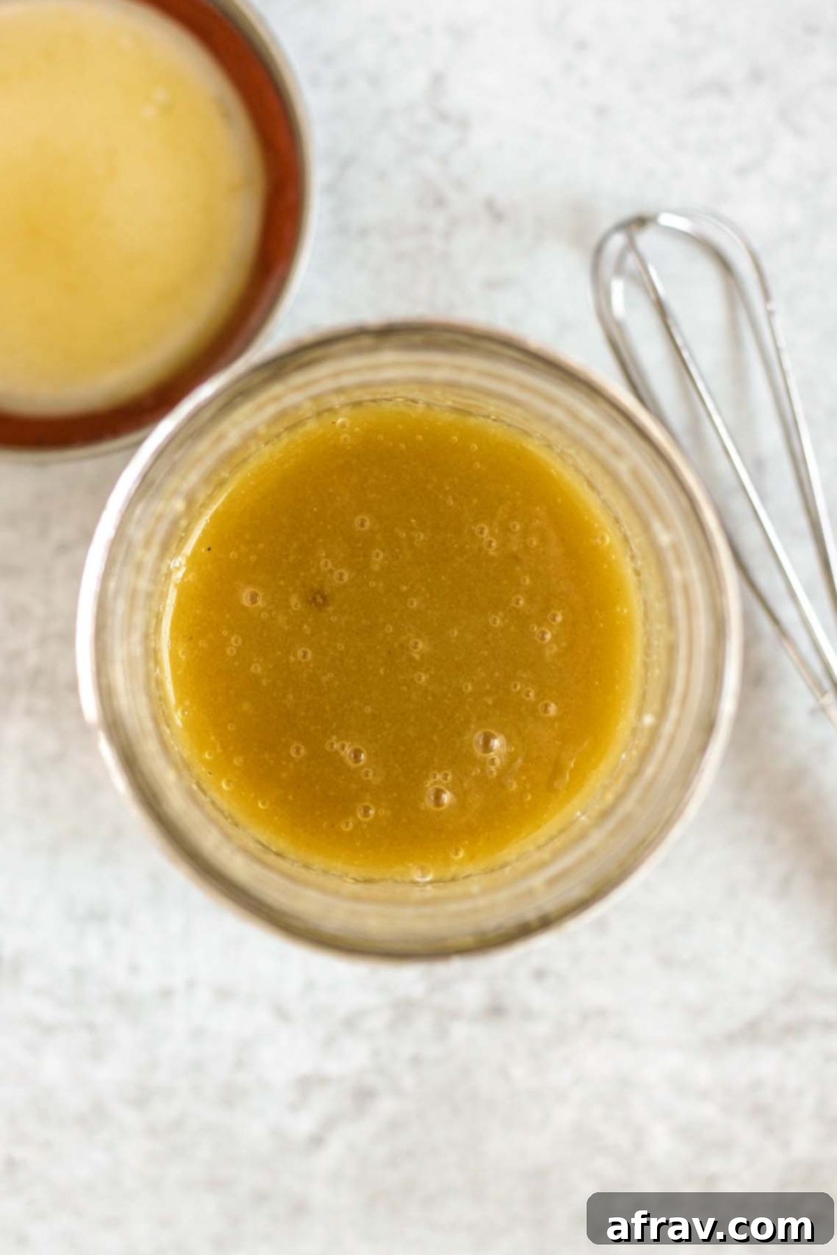Maple Dijon dressing shook up on a mason jar.