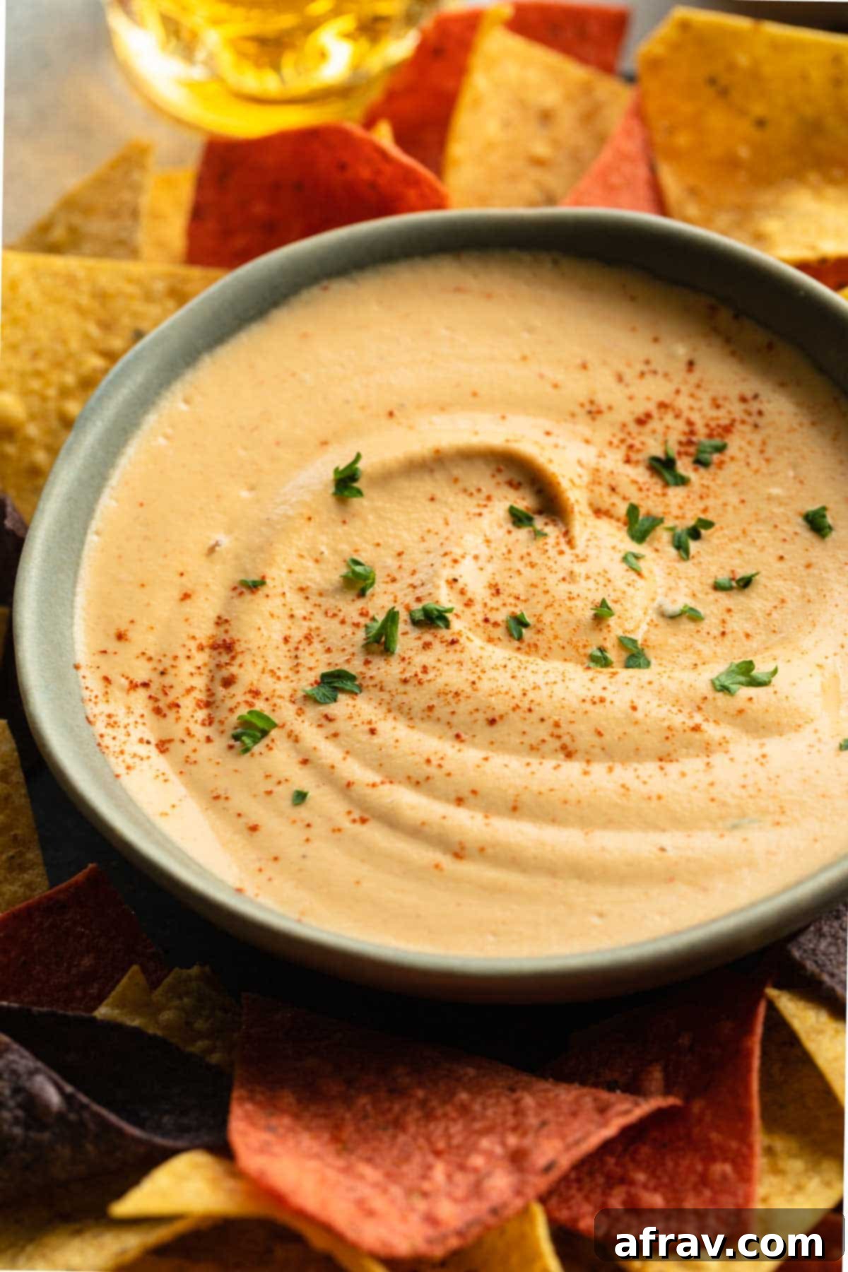 Close up shot of the smooth and creamy cashew chipotle dip in a light blue bowl, showcasing its perfect texture.