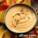 Overhead view of cashew chipotle dip in a blue bowl.