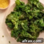 Air Fryer Kale Chips arranged on a pink plate.