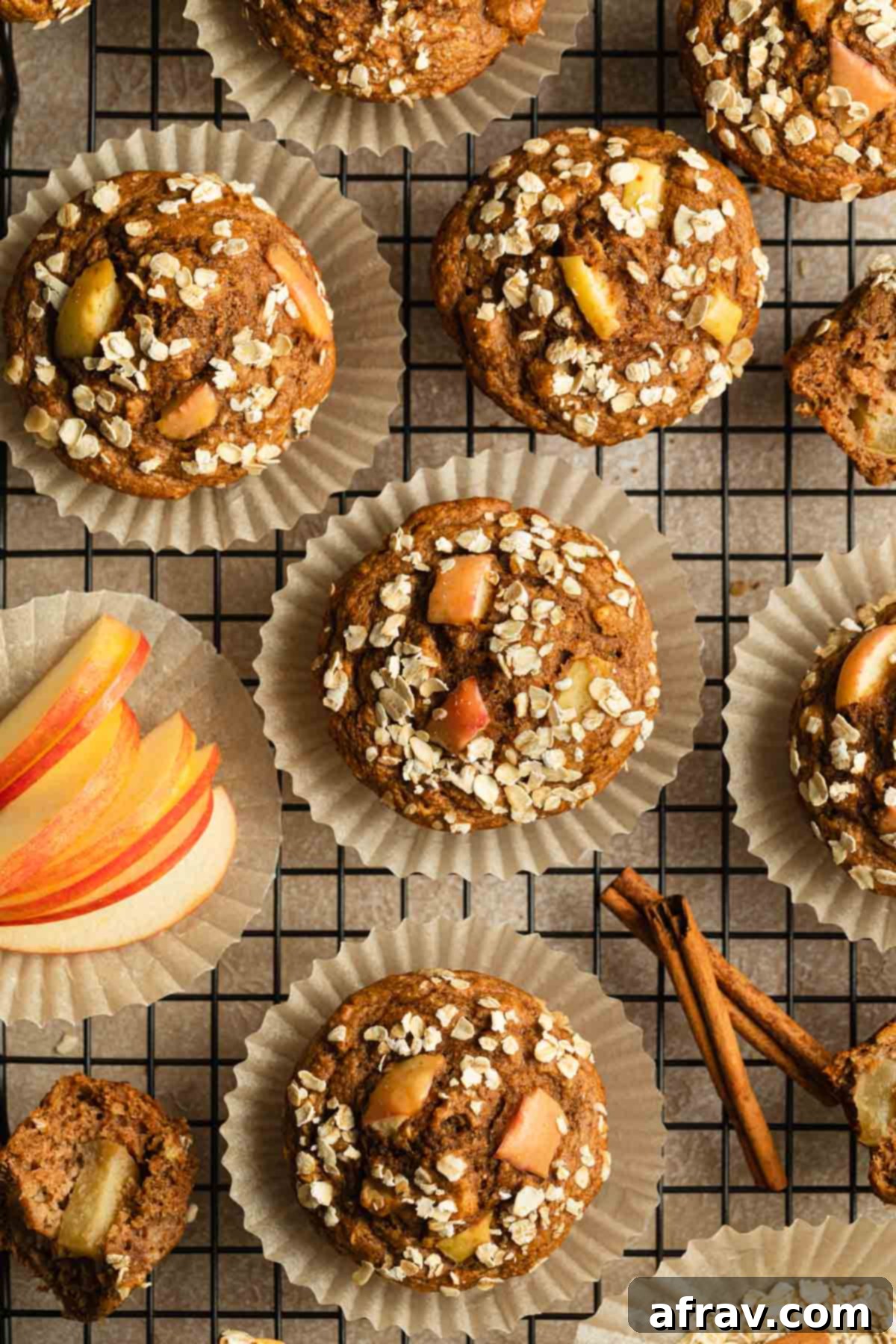 Freshly baked apple spice muffins cooling on a wire rack, ready to be enjoyed.