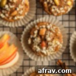 Apple spice muffins arranged in muffin liners on a cooling rack, fresh from the oven.