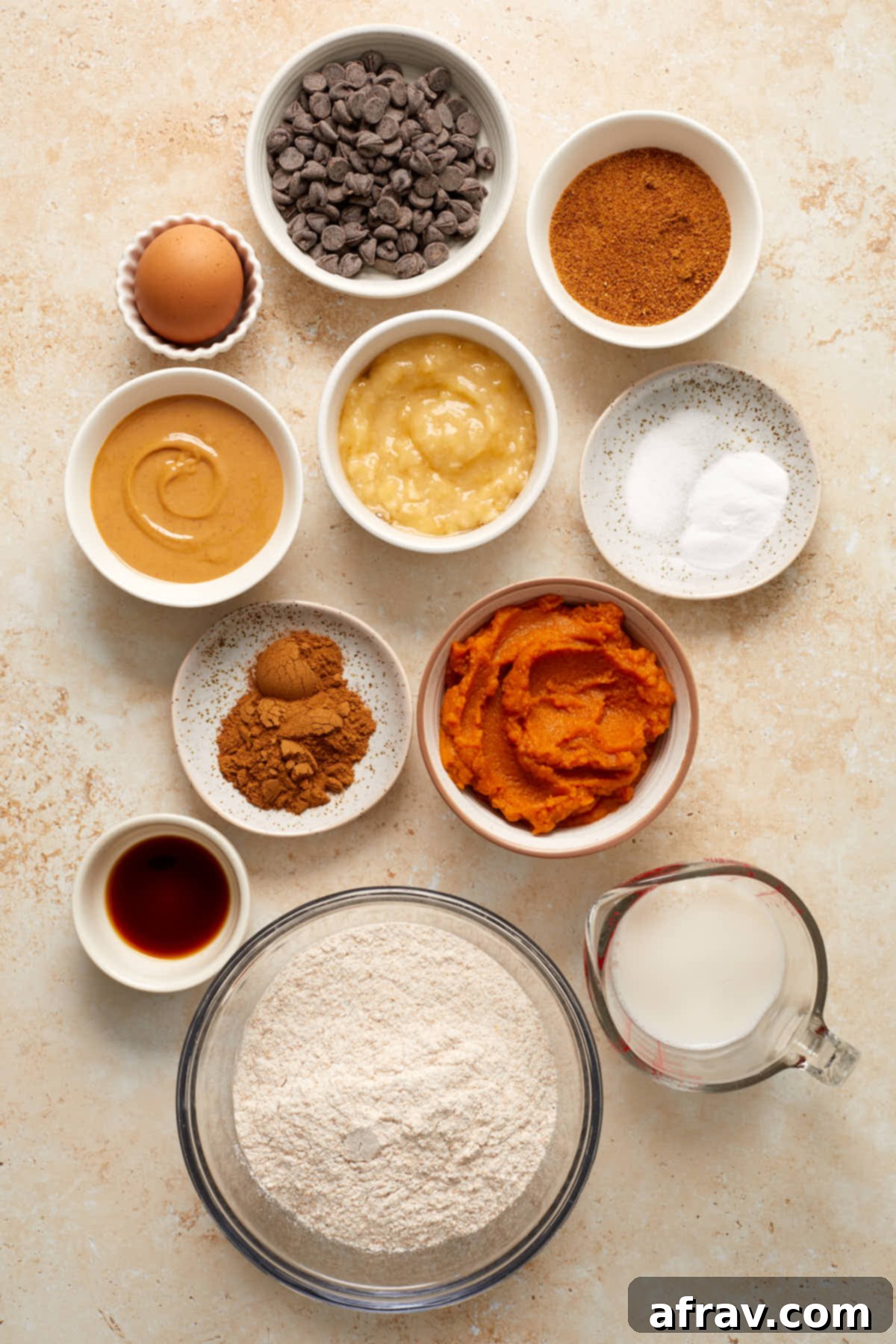 Ingredients to make pumpkin banana muffins arranged in individual dishes.