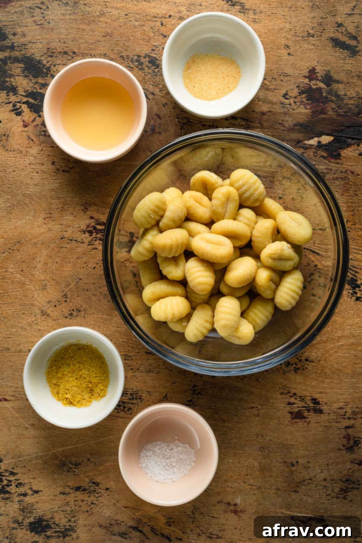 Crispy Air Fryer Gnocchi 3 Ingredients to make air fryer gnocchi arranged in individual bowls, including gnocchi, avocado oil, nutritional yeast, garlic powder, and salt.
