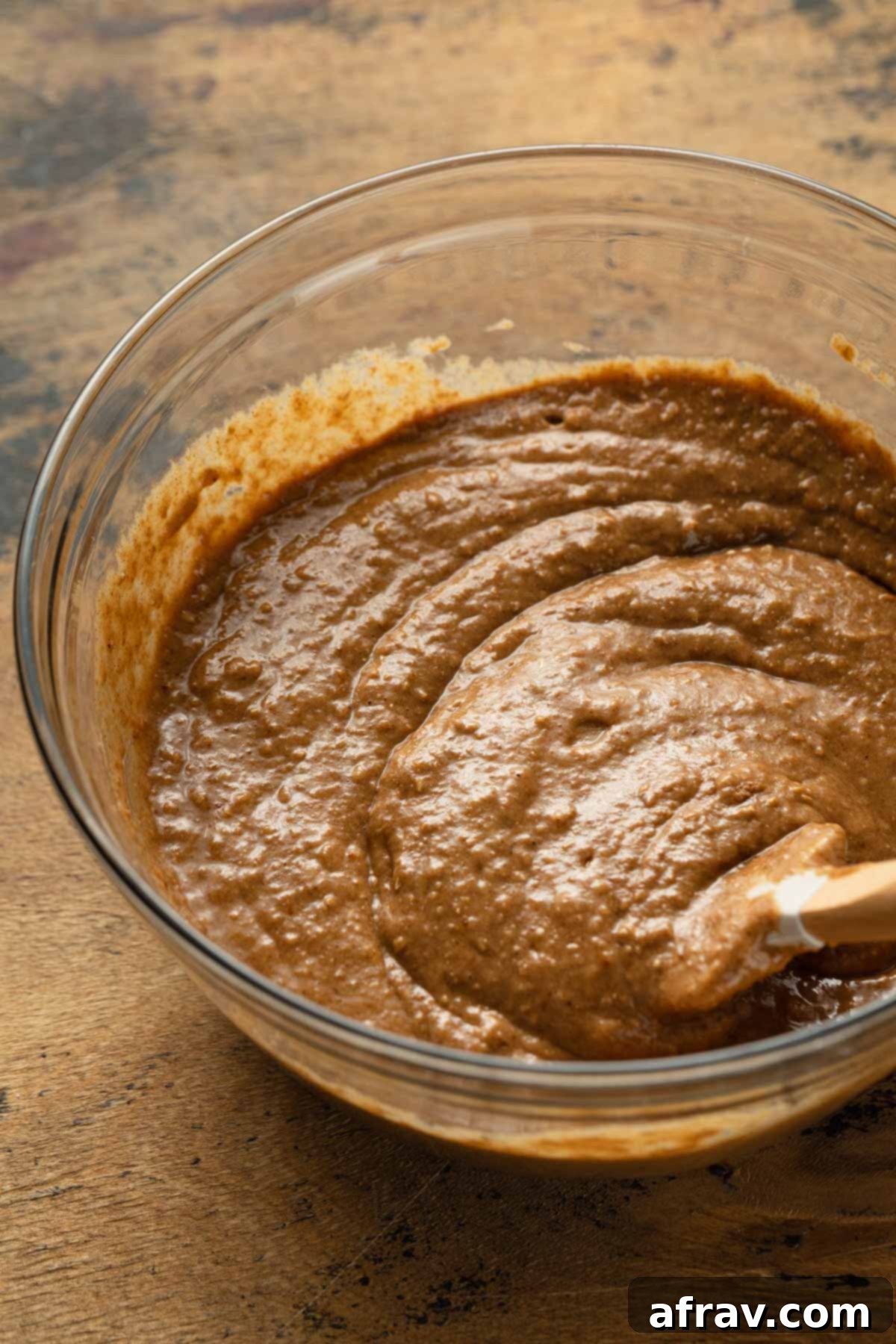 Cake batter mixed together in a glass bowl, ready for baking.