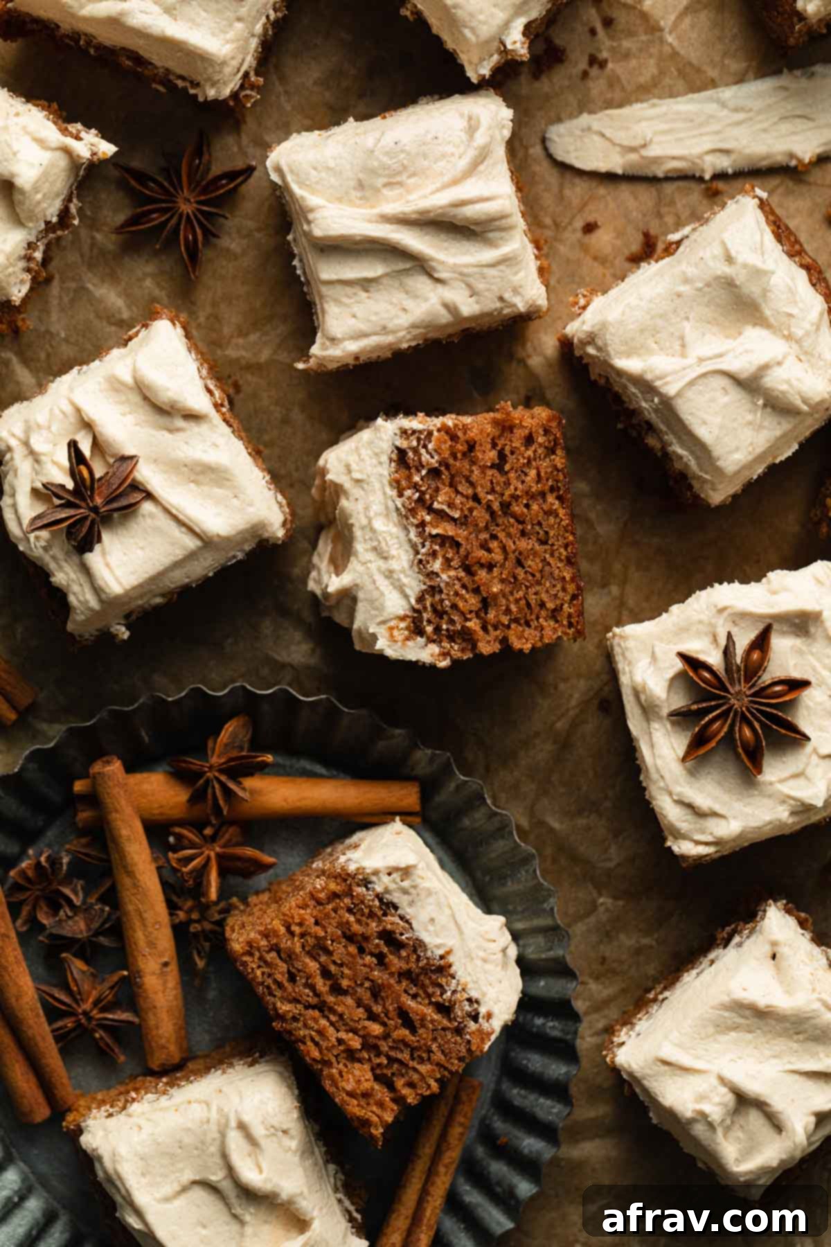 Overhead view of pieces of apple spice cake with creamy buttercream frosting arranged on a rustic wooden backdrop.