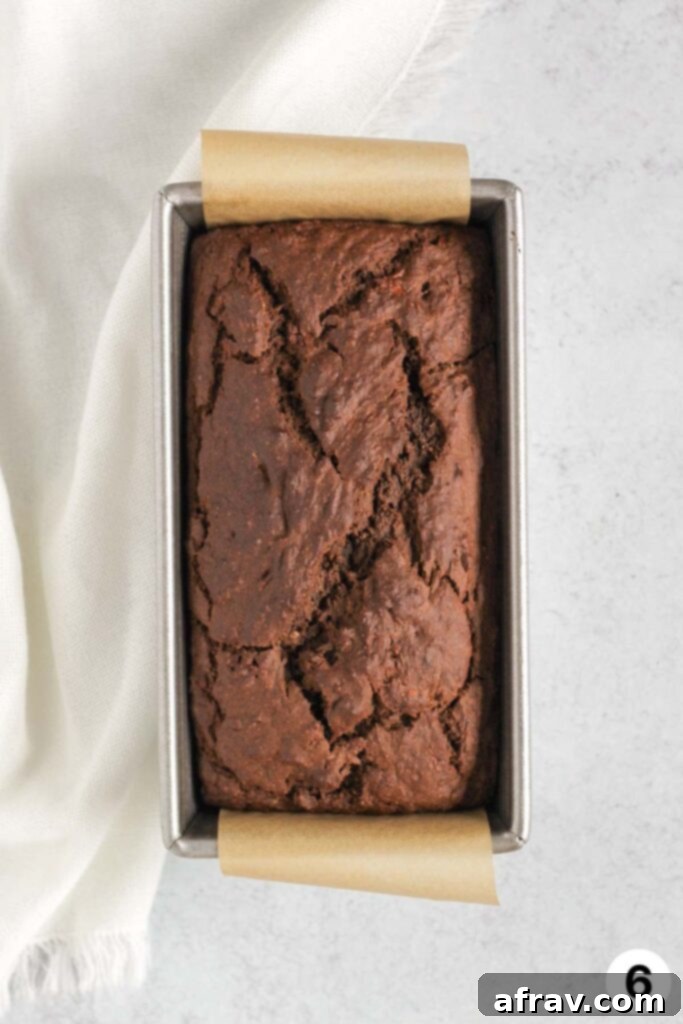 Cooked chocolate banana protein bread in a loaf pan with a number 6 in the corner.