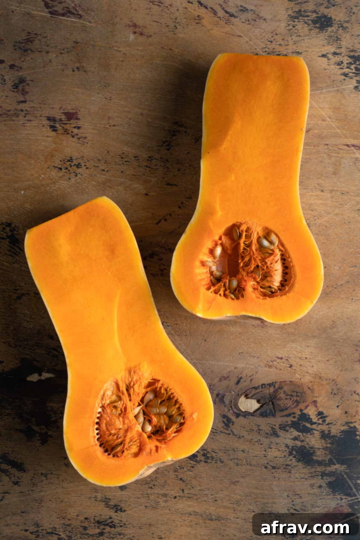 Butternut squash cut in half, flesh side up, ready for roasting.