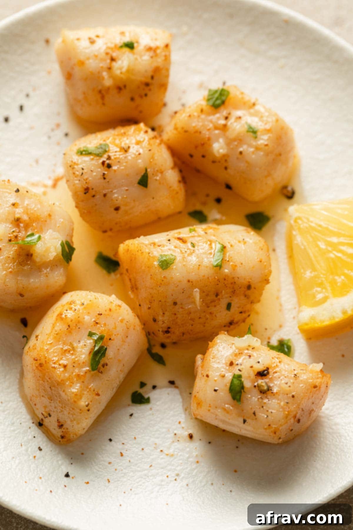 Air Fryer Scallops 6 Up close view of air fried scallops topped with melted butter and chopped parsley.