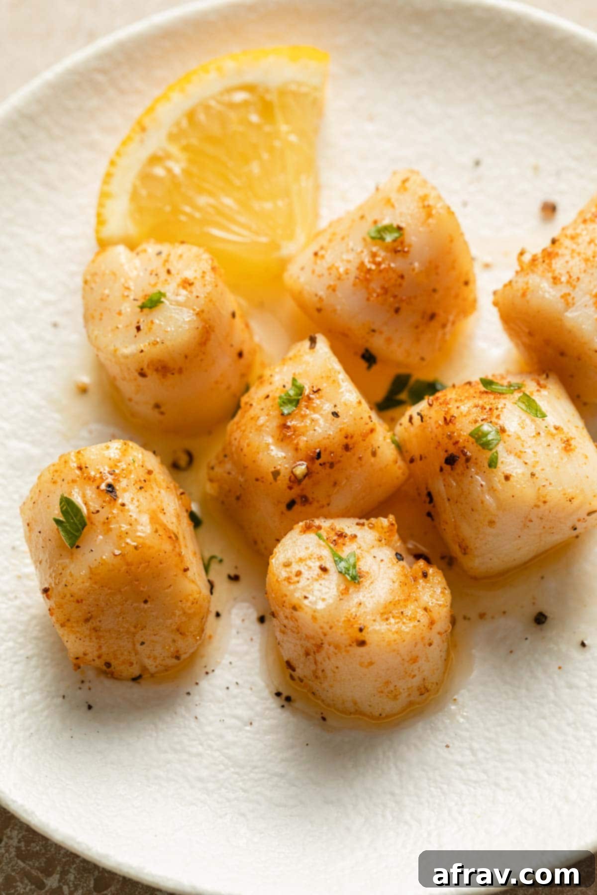 Air Fryer Scallops 8 Close up of air fryer scallops on a white plate.
