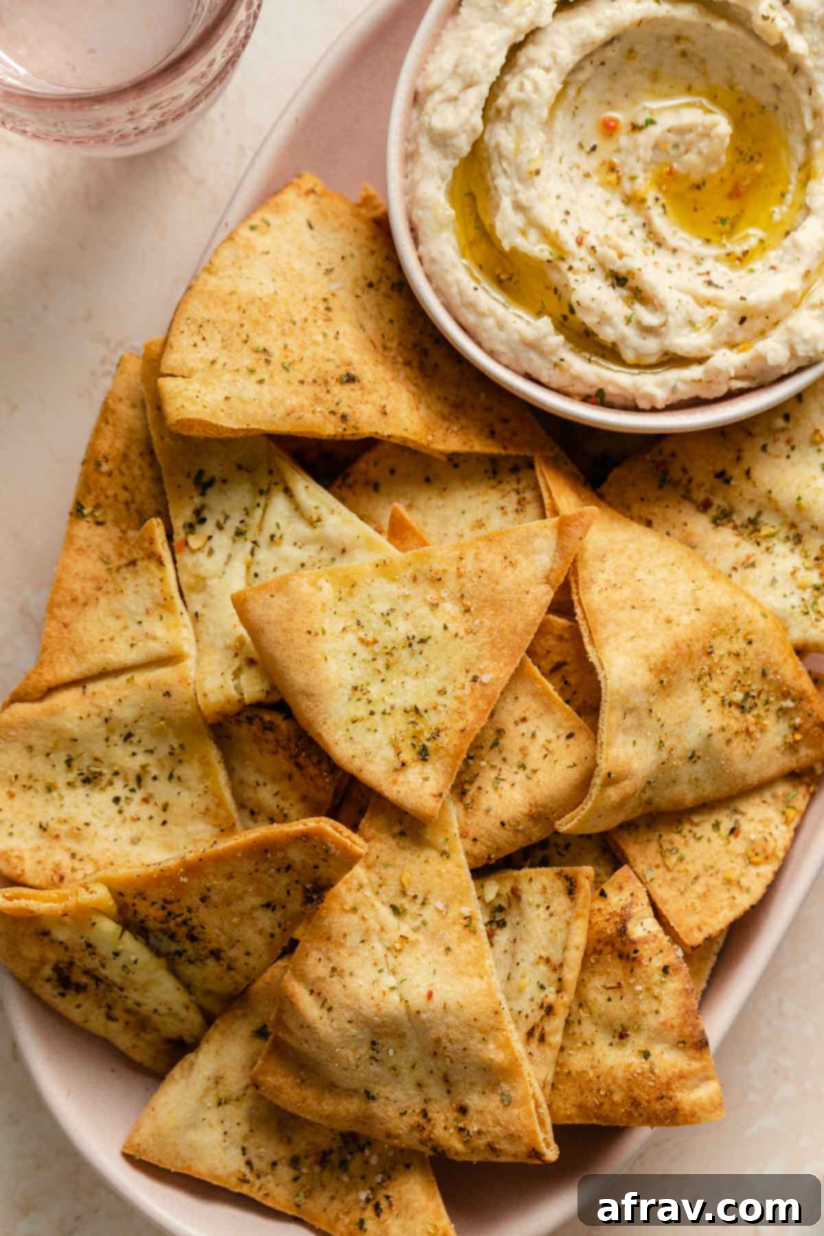 Pita chips served with a small bowl of dip.