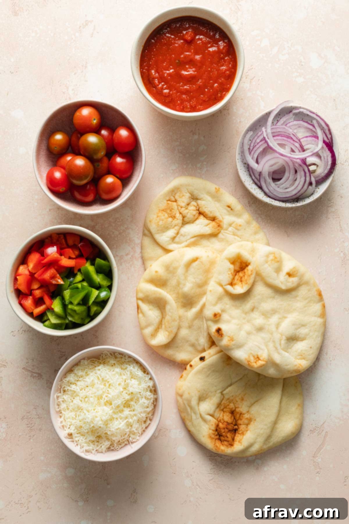 Ingredients to make air fryer mini pizzas arranged individually.