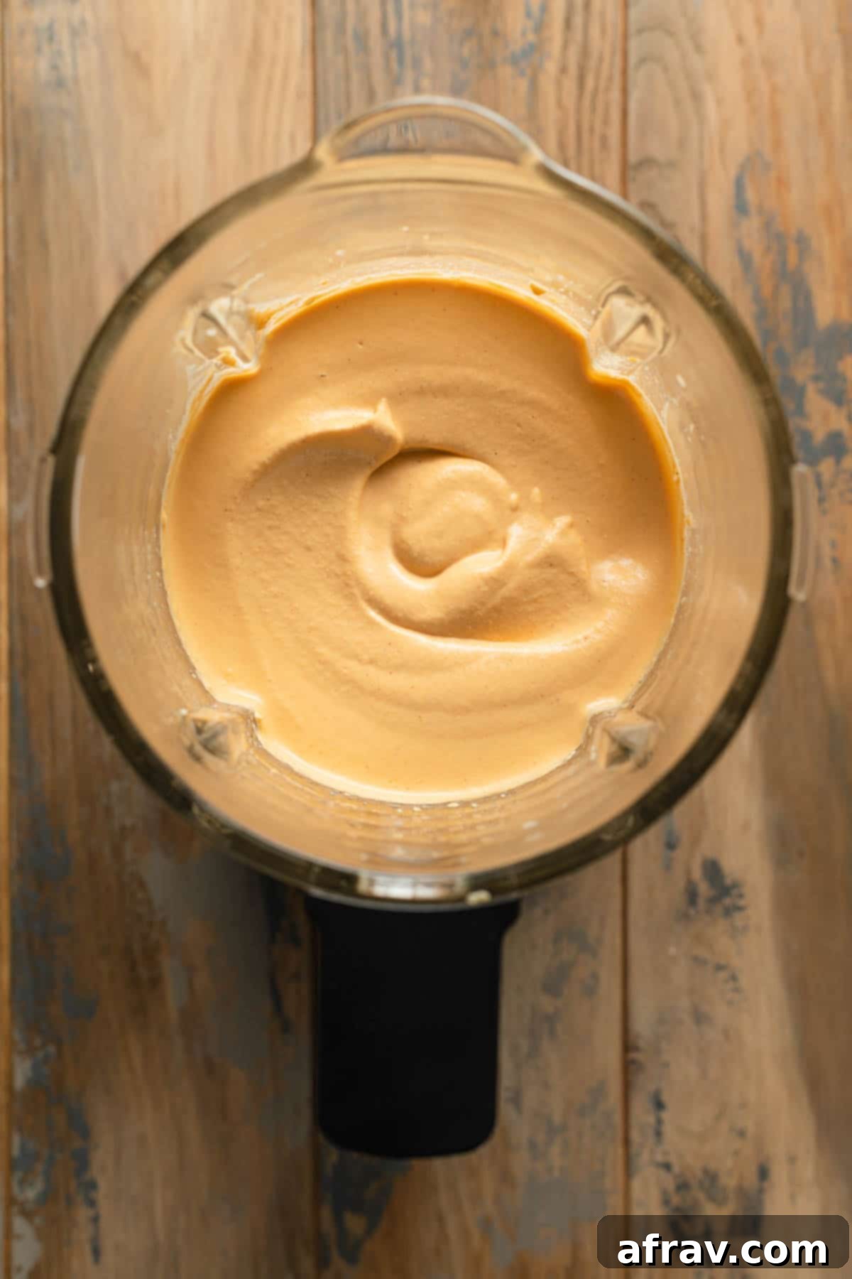Creamy Dairy-Free Buffalo Chicken Dip 4 Cashews and other ingredients blended together in a blender.