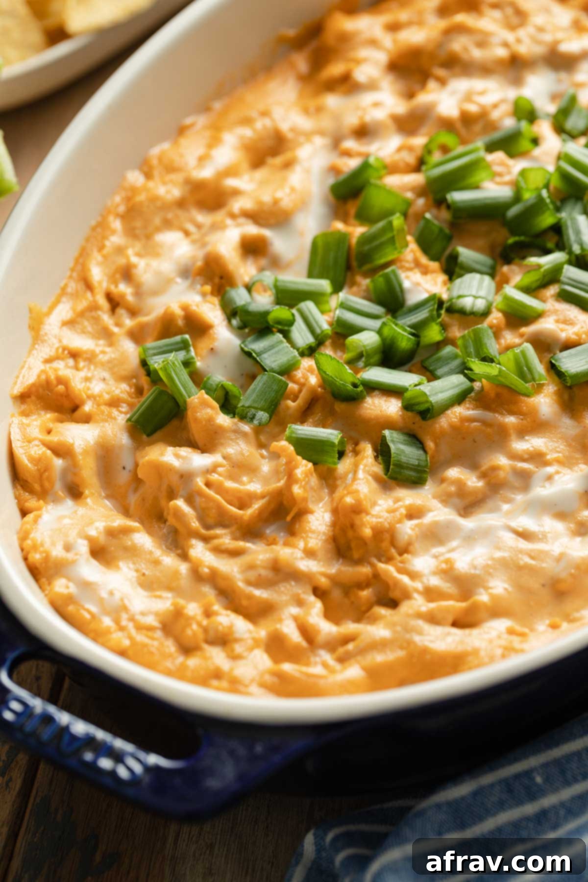 Creamy Dairy-Free Buffalo Chicken Dip 6 Close up view of buffalo chicken dip topped with chopped green onions.