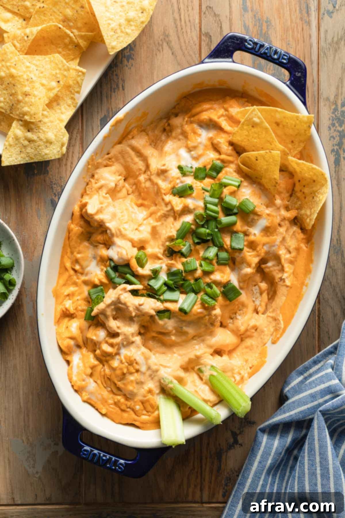 Creamy Dairy-Free Buffalo Chicken Dip 7 Half eaten buffalo chicken dip in an oval dish.