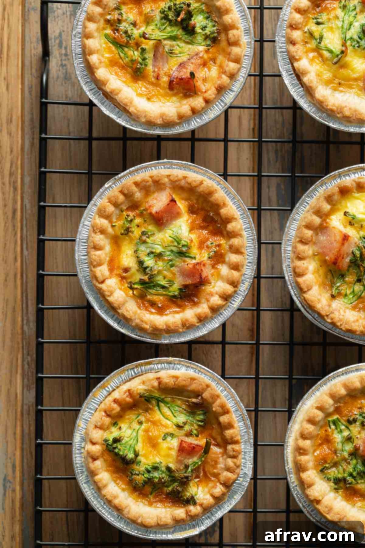 Close up of mini quiches arranged on a wire rack.