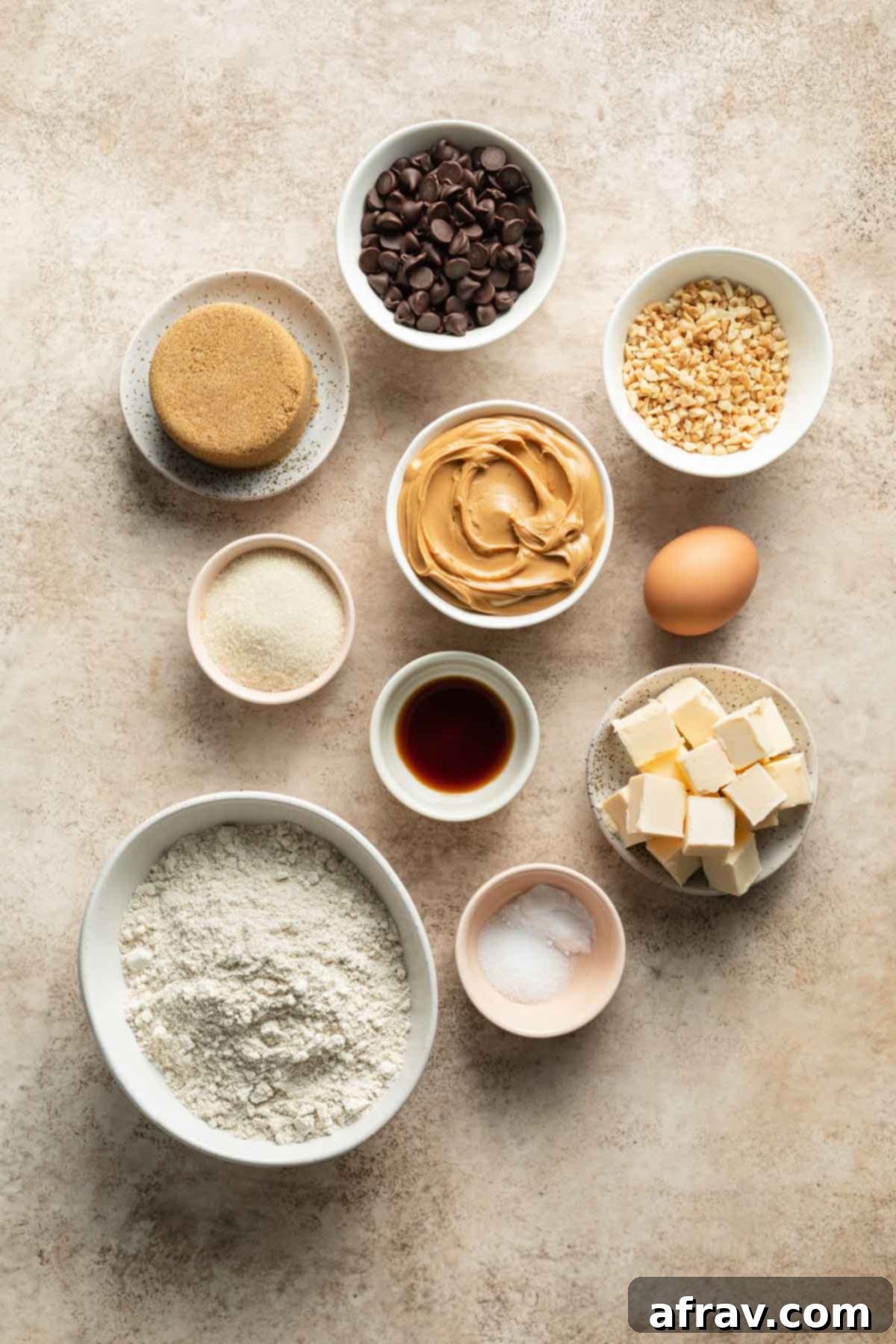A beautiful flat lay of all the ingredients needed to make oat flour chocolate chip cookies, neatly arranged on a light surface.