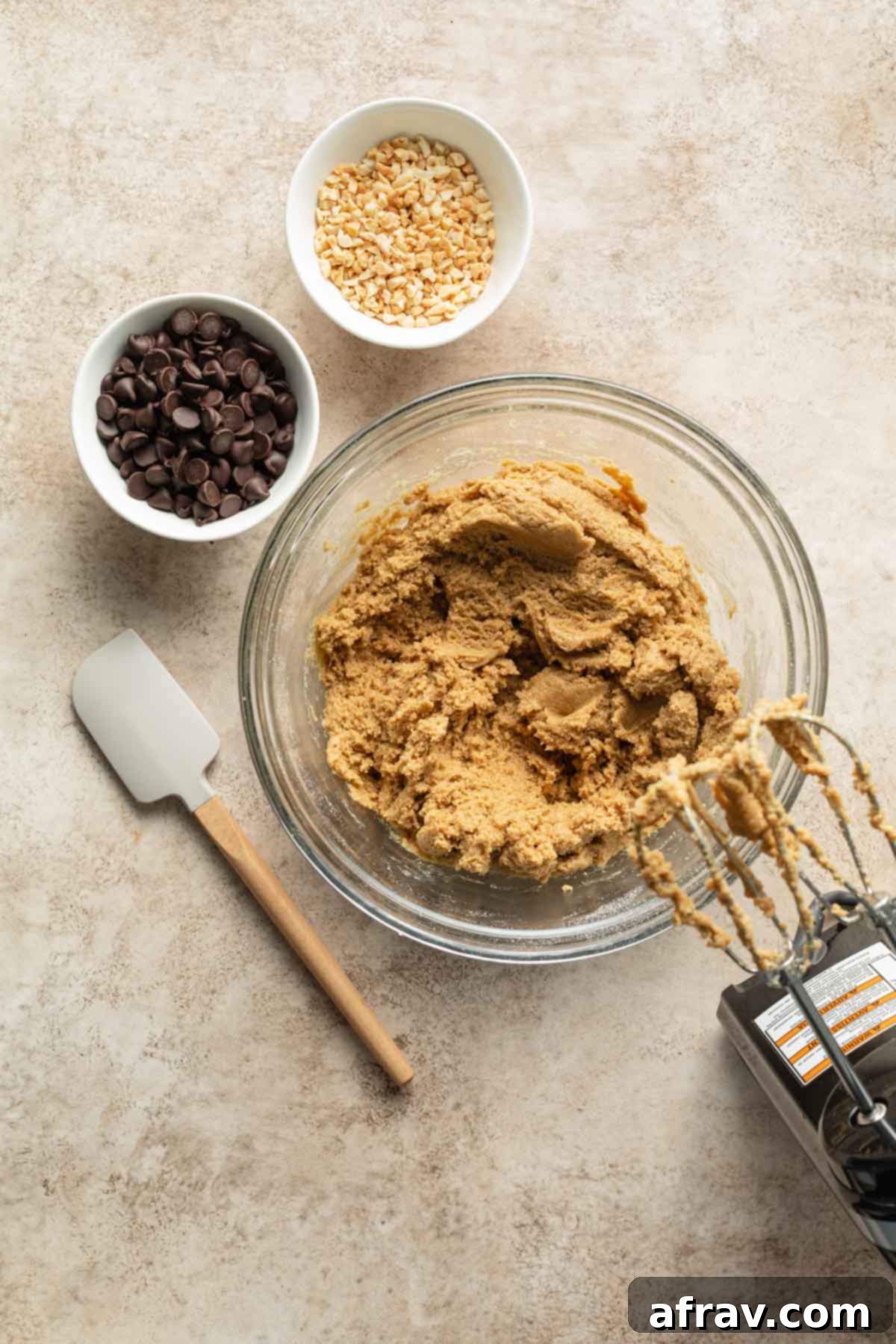 Cookie dough beat together in a glass bowl, showcasing a uniform and well-mixed texture.