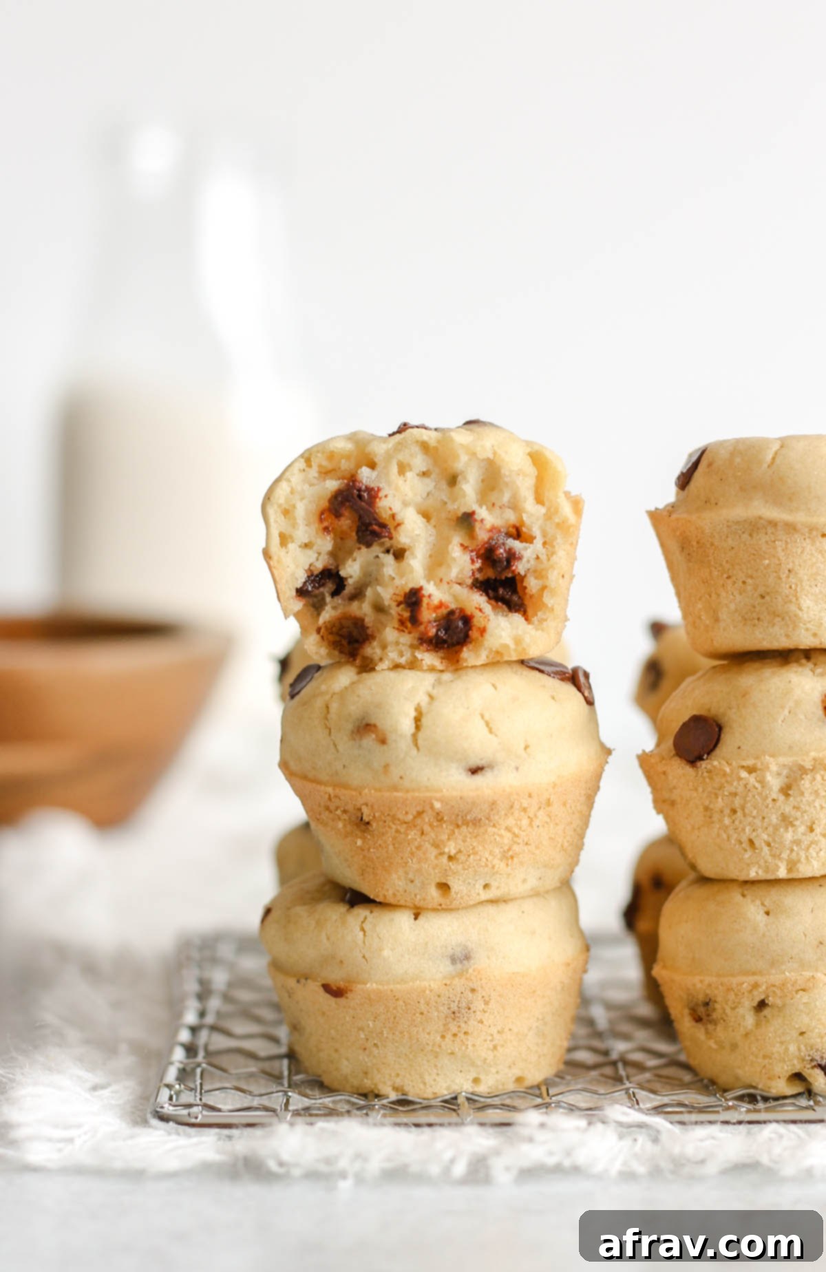 Gluten-Free Dairy-Free Mini Chocolate Chip Muffins 2 Stacked chocolate chip mini muffins, showcasing their golden-brown tops and rich chocolate chips.