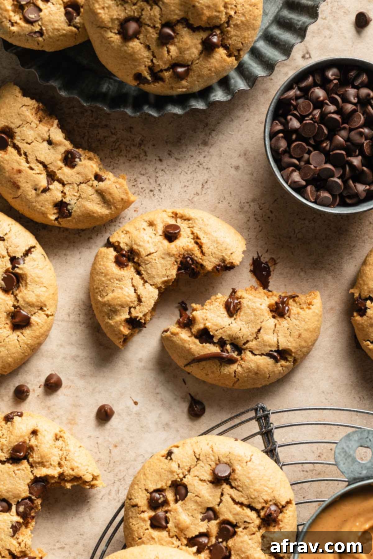 Overhead view of a cookie broken in half next to other cookies.
