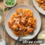 Air fryer turkey meatballs served on a plate with marinara sauce and pasta.