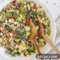 Healthy Broccoli Kale Salad in a bowl with a clean eating logo