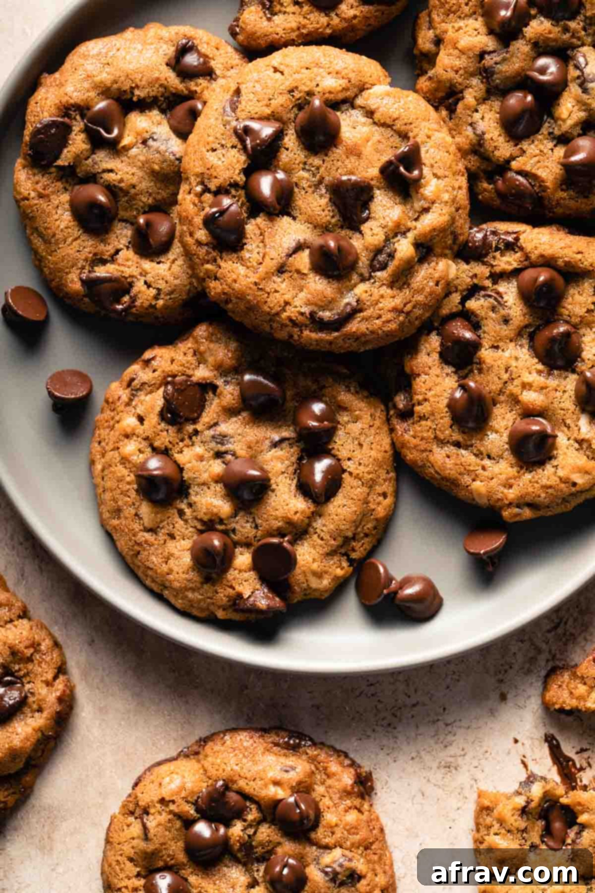 Irresistible Air Fryer Chocolate Chip Cookies 8 Close-up view of a stack of air-fried chocolate chip cookies on a gray plate, with visible chocolate and a slightly crispy texture.