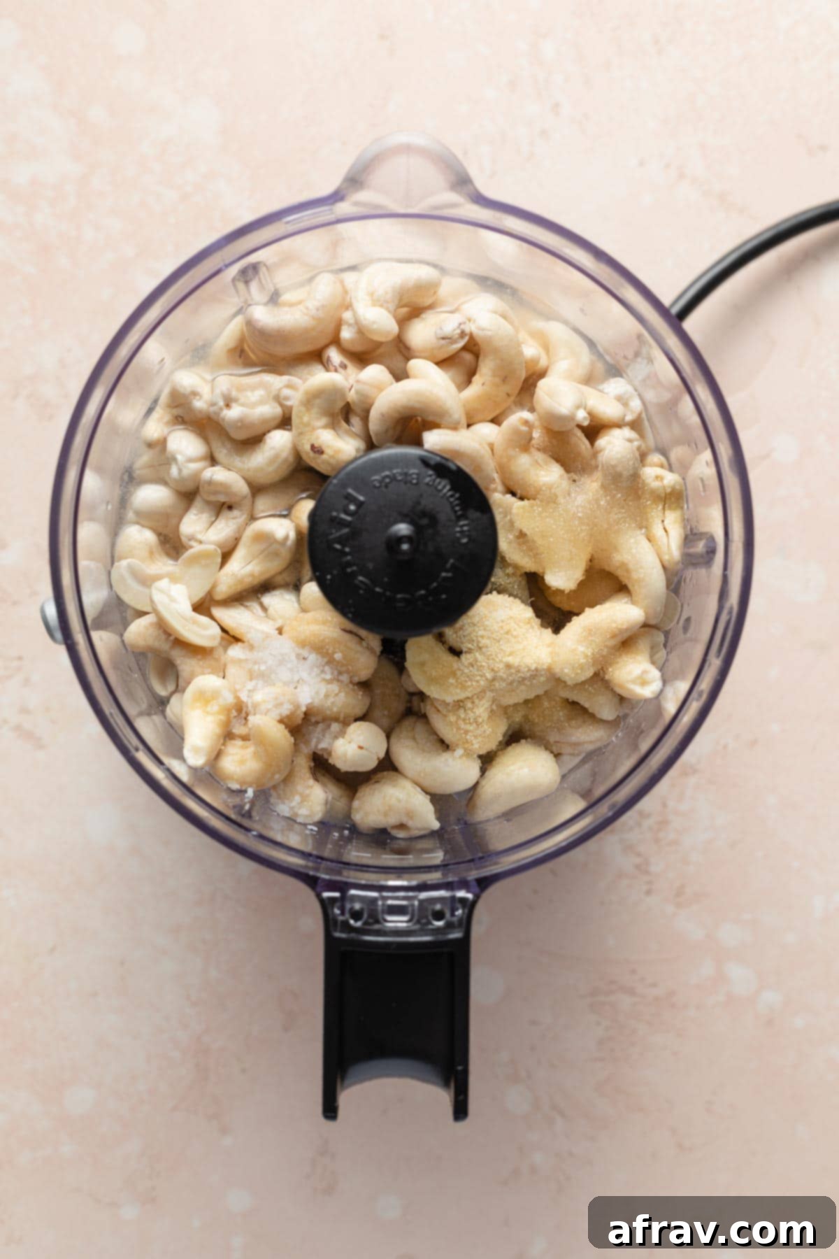 Cashews and other mayo ingredients placed in a food processor, ready for blending.