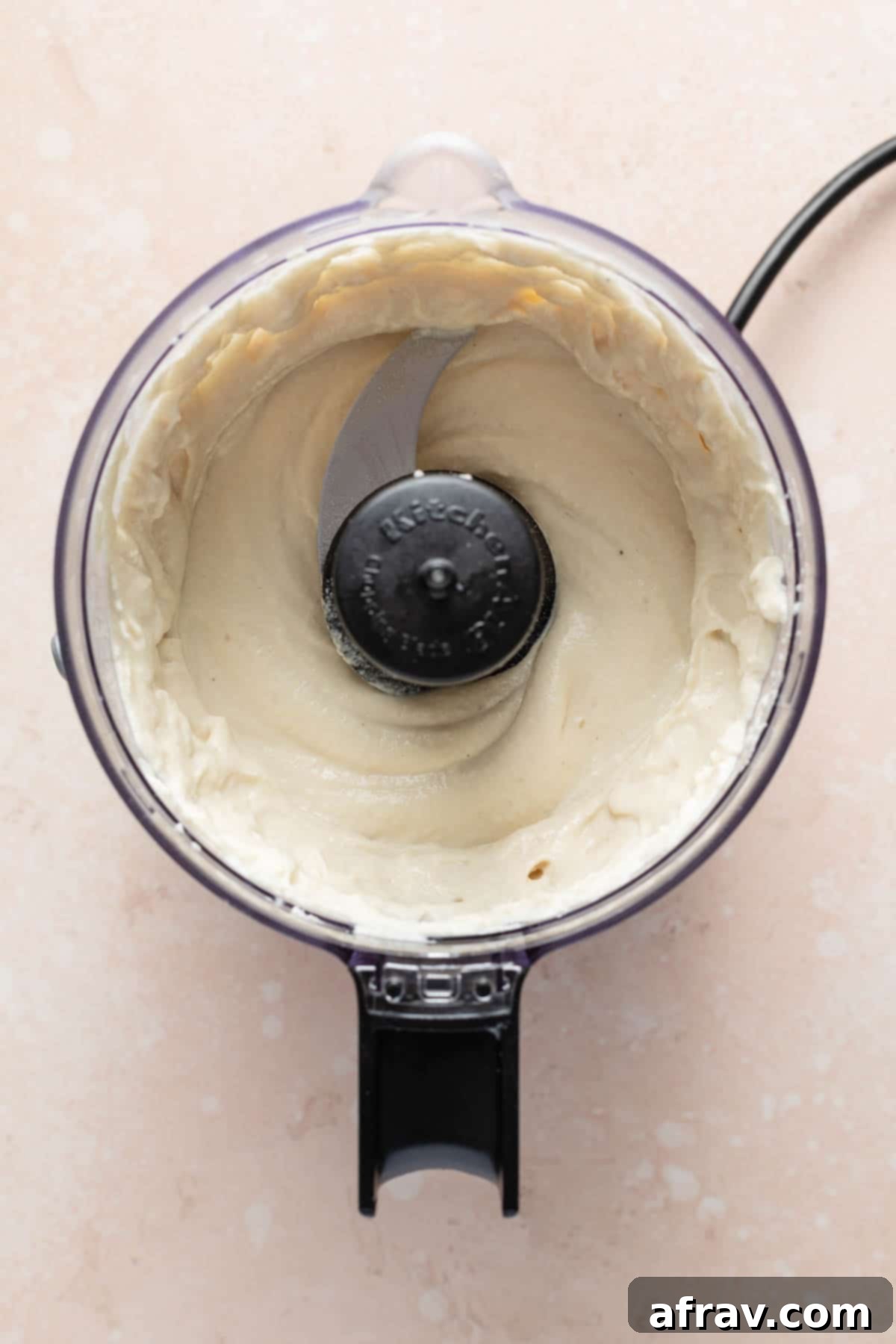 Cashew mayo perfectly blended and smooth in a food processor, ready for chilling.