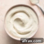 Cashew mayo (vegan mayonnaise) in a pink bowl.