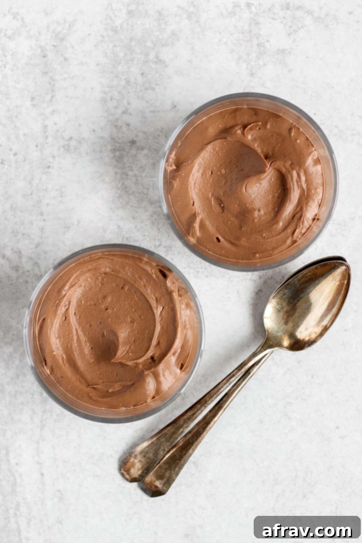 Vegan chocolate mousse in 2 single size glass serving dishes.