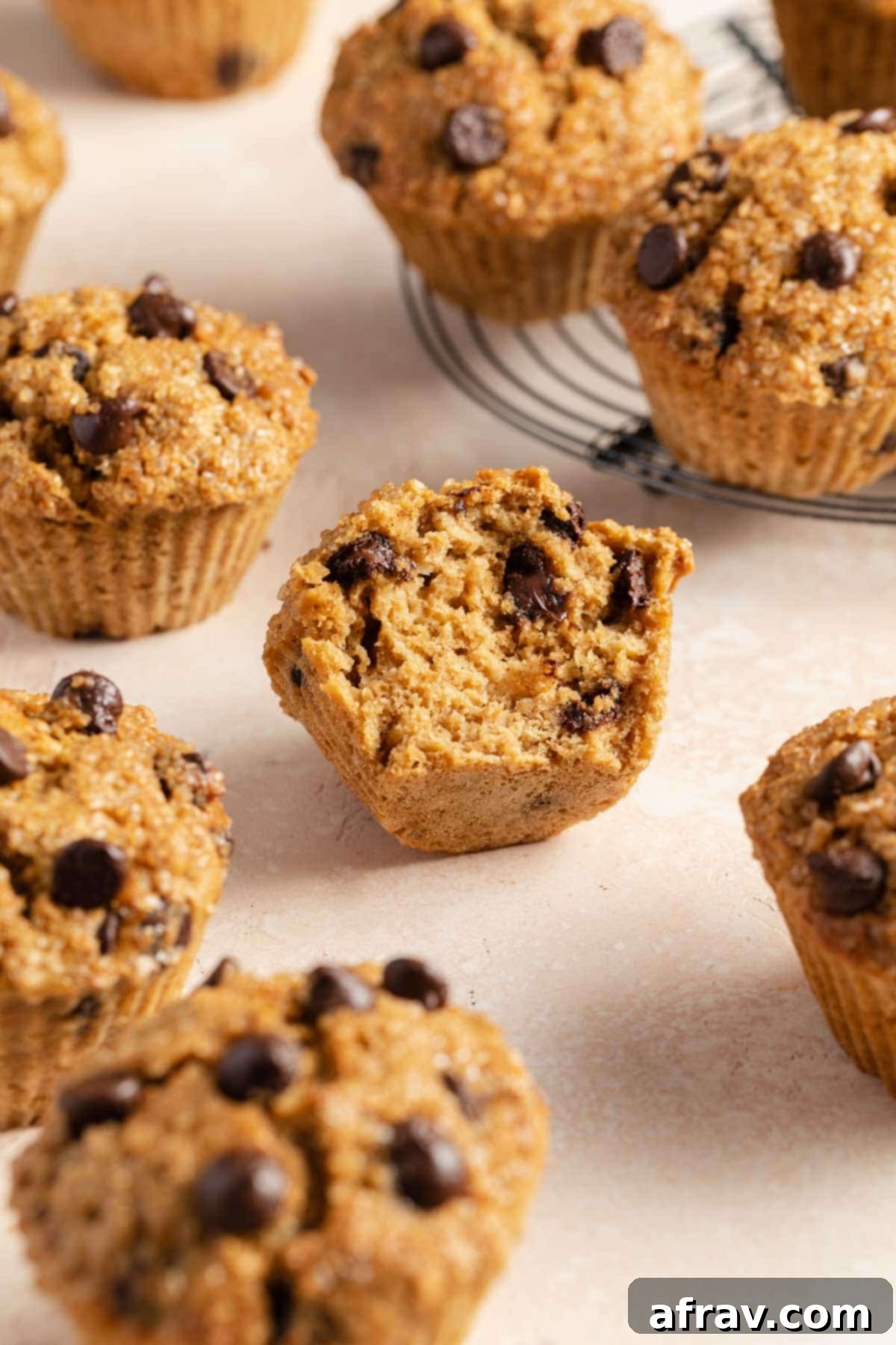 Chocolate chip oatmeal muffins with a bite taken out of one.